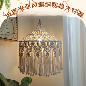 Detailed view of hand-woven cotton macrame lampshade with geometric mesh and fringe