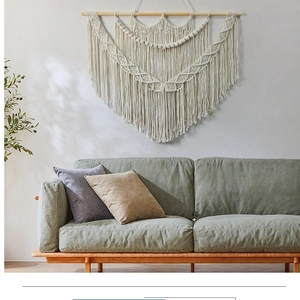 Detail showing the intricate woven texture and fringe of this large boho macrame wall hanging