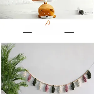 Detail of Nordic wooden bead garland with colorful cotton tassels for wall hanging decor