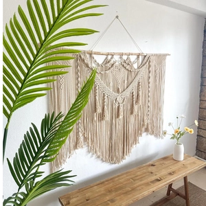 Detail of bohemian hand-woven tapestry showing intricate cotton rope macrame patterns