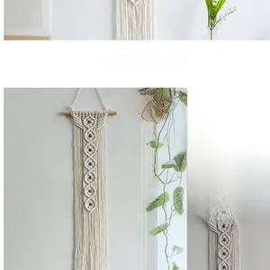 Detail of bohemian handmade cotton rope wall hanging with evil eye bead decorations