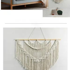 Detail of bohemian handmade woven wall hanging featuring cotton ropes and wooden stick