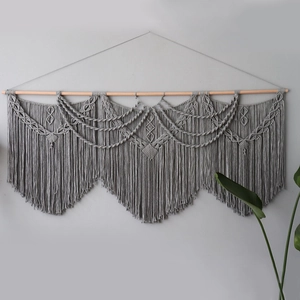 Handmade grey bohemian macrame wall hanging with geometric weaving and tassels