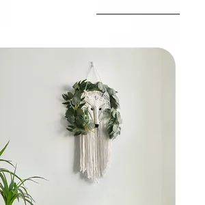 Detail of handmade macrame fox wall hanging with artificial eucalyptus leaf decor
