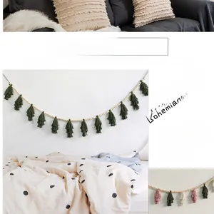 Detail of bohemian wood bead garland with colorful cotton tassels for wall hanging decor