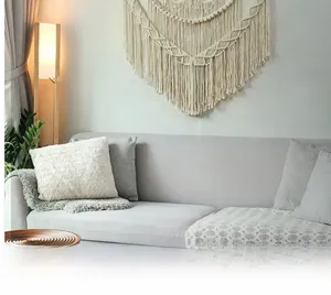 Detailed view of hand-woven macrame tapestry with geometric patterns and fringe