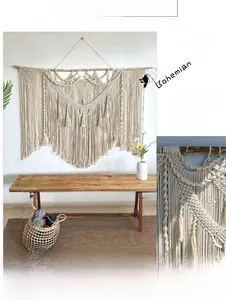 Detailed macro view of bohemian hand-woven macrame wall hanging with cotton fringe tassels