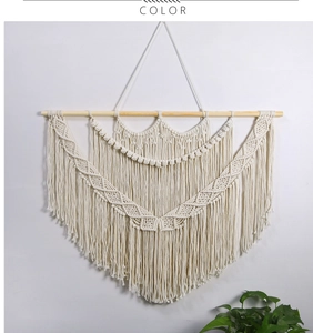 Close-up of bohemian hand-woven macrame tapestry showing complex patterns and long fringe