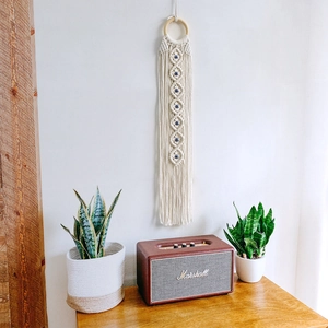 Handmade boho macrame wall hanging with evil eye beads and tassels for home decor