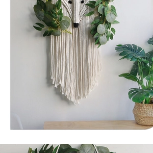 Detailed macro of handmade fox cotton tapestry with woven fringe and green leaf accents