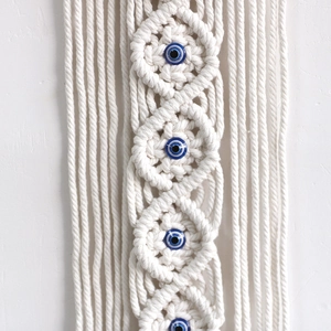 Handwoven boho macrame wall hanging with blue evil eye beads for home decor