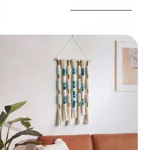 Detailed close-up of handmade Bohemian wall tapestry with intricate blue and gold knots