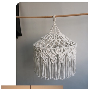 Detail of hand-woven bohemian cotton rope lampshade featuring macrame patterns and fringe