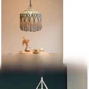 Close-up of bohemian hand-woven cotton lamp shade with fringe in a warm dining room