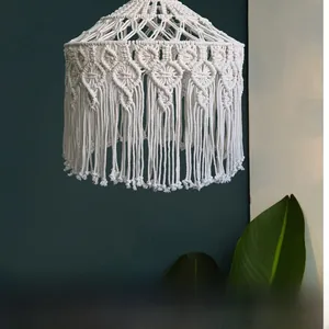 Detail of handmade macrame lampshade with tassel trim and diamond pattern fringe