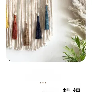 Detail of macrame wall hanging with colorful tassels and wooden beads in a boho home setting