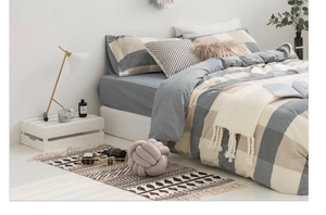 Detailed view of gray and beige checkered bedding set with modern plaid pattern texture