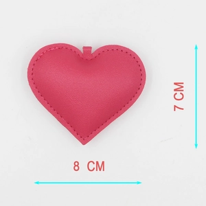 Detail view of 8cm pink PU leather heart charm with litchi texture and stitching