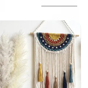Detail of bohemian handmade woven tapestry with colorful rainbow yarn and long tassels