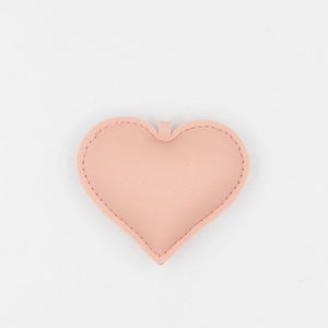 Pink heart-shaped PU leather keychain accessory with precise stitching on white background