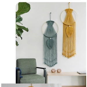 Detailed view of handmade bohemian wall hanging with teal and mustard fringe textures