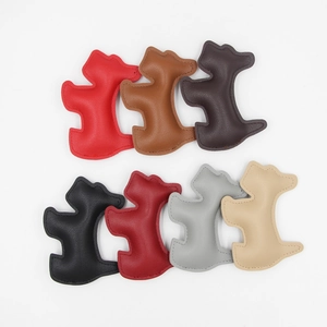 Collection of dog-shaped leather bag charms in seven various colors with stitching detail