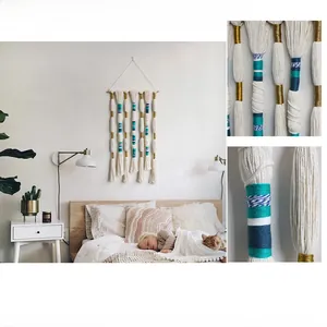 Close-up of bohemian woven tapestry featuring turquoise and gold accents on beige cotton