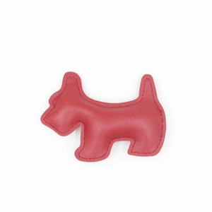 Detailed view of red leather dog charm featuring precise stitching and realistic texture