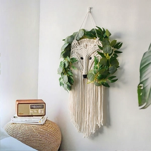 Handmade fox macrame wall hanging with eucalyptus leaves in a boho home decor setting