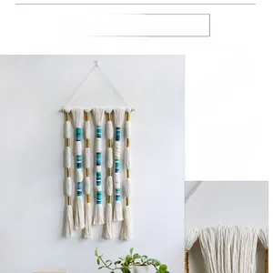 Close-up of bohemian wall hanging featuring handmade cotton rope and colorful thread details