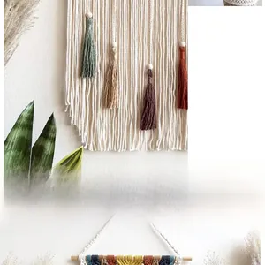 Detailed view of handmade macramé wall hanging with colorful cotton fringe and wooden rod