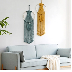 Detail of handcrafted macrame wall hanging with leaf patterns and elegant cotton tassels