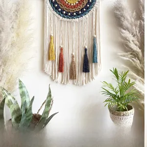 Detail of bohemian woven tapestry with colorful fringes and handmade cotton rope texture