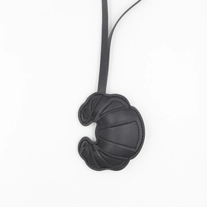 Creative black leather croissant bag charm and keychain with a long leather strap accessory