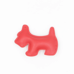 Detailed view of red lychee textured leather dog bag charm with premium stitching