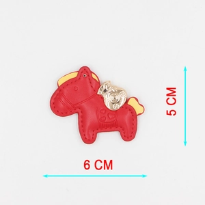 Detail of red leather horse keychain with golden money bag and precise dimensions