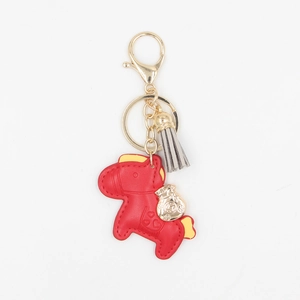 Porte-clés cheval rouge en cuir avec breloque sac d'argent doré et pompon gris