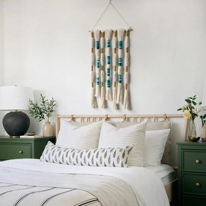 Handwoven Bohemian wall hanging tapestry with tassels and gold accents on a wooden rod