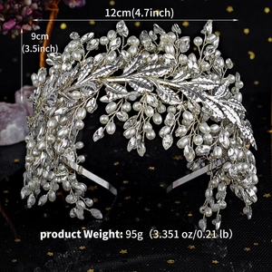 Detailed view of silver flower headband with pearls and rhinestones on black background