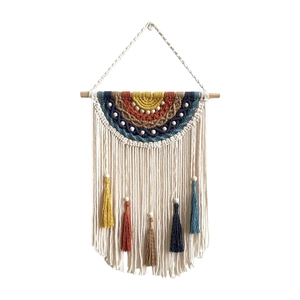 Bohemian woven tapestry wall hanging with colorful rainbow patterns and tassels