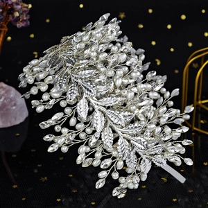 Detailed close-up of handmade metallic flower hairband with pearls and rhinestones