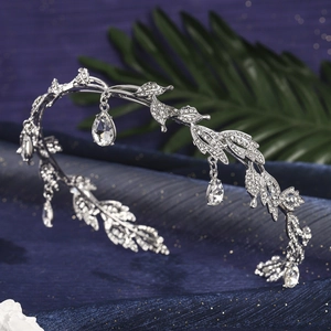 Detailed close-up of a silver leaf crown with rhinestones and pear-shaped crystal drops