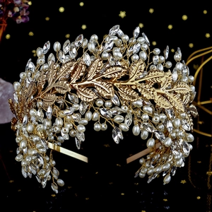 Detail of luxury gold metal leaf headband with handmade pearls and sparkling crystals