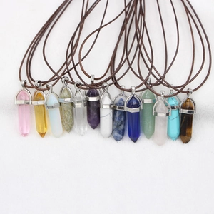 Flat lay view of hexagonal natural stone crystal pendants with wax cord necklaces