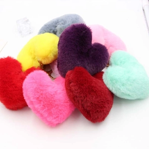 Detailed top view of various colorful plush heart keychains with gold metal clasps