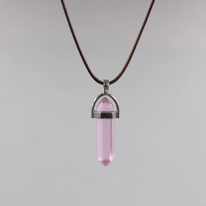 Close-up of pink hexagonal crystal pendant with silver clasp on brown wax cord