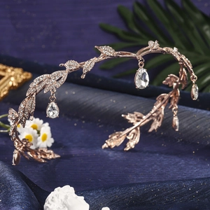 Detail of rose gold tiara with leaf design, inlaid rhinestones and waterdrop pendants