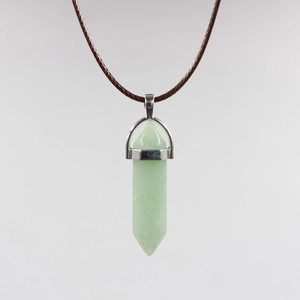Detailed macro view of light green hexagonal crystal pendant with silver clasp on cord
