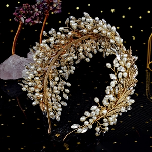 Macro shot of handcrafted gold wire branch texture with pearls and rhinestones