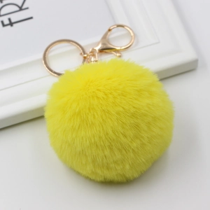 Vibrant yellow faux rabbit fur pom-pom keychain with gold lobster clasp and ring